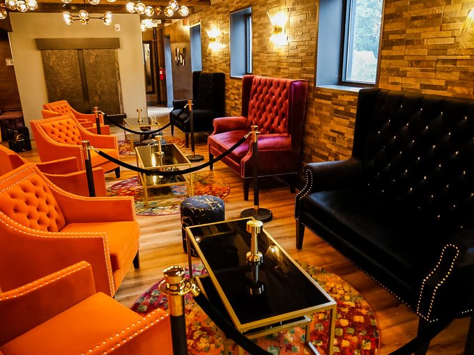 Marquee's lounge: velvet seating, brass tables and low light.